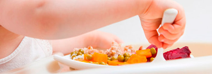 Niño pequeño probando un plato nuevo