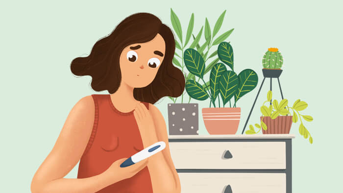 Ilustración de una mujer mirando un test de embarazo